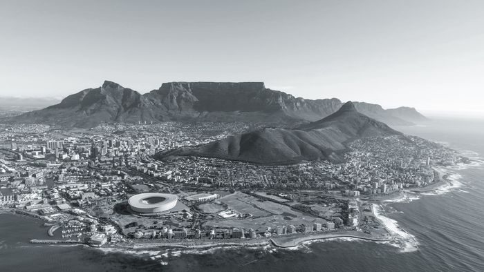 Cape Town from the air, with Table Mountain behind the city and the coast