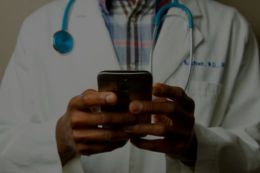 A clinician checking patient information on a phone